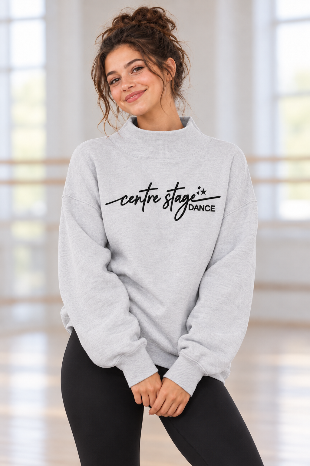 Centre Stage Dance gray embroidered mock-neck sweatshirt on an adult model in a dance studio; product mockup